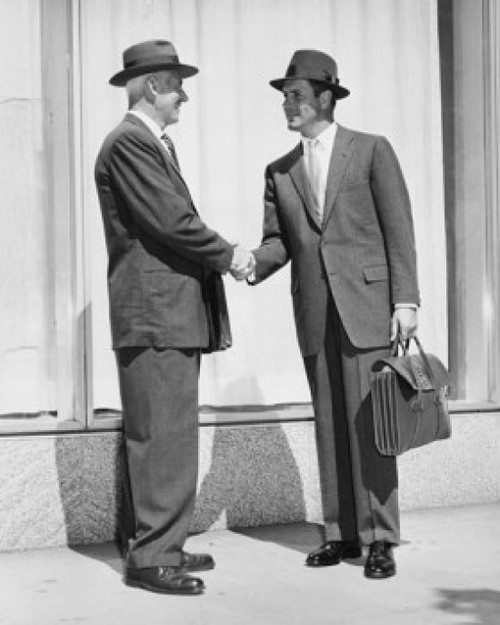 Side profile of two businessmen shaking hands Poster Print