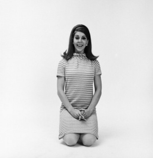 Portrait of a young woman kneeling on the floor and smiling Poster Print - Item # VARSAL25541920