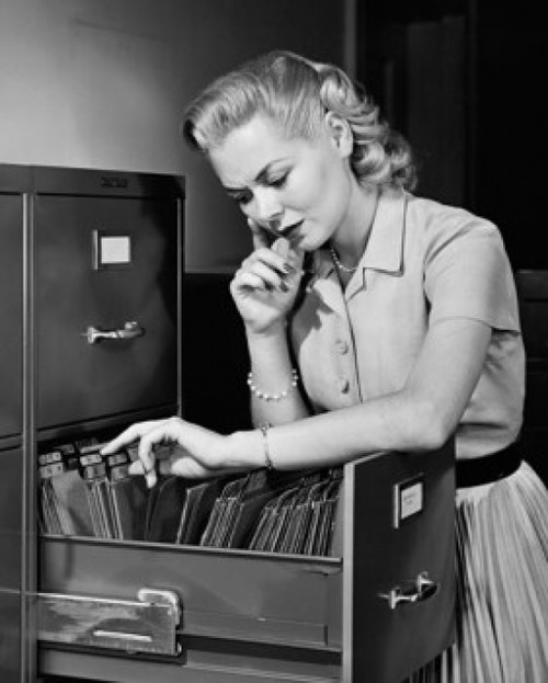 Businesswoman searching for files in a filing cabinet Poster Print - Item # VARSAL25548414