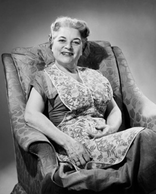 Portrait of a senior woman sitting on an armchair Poster Print - Item # VARSAL25528155B
