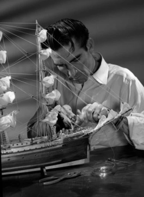 Man building model ship Poster Print