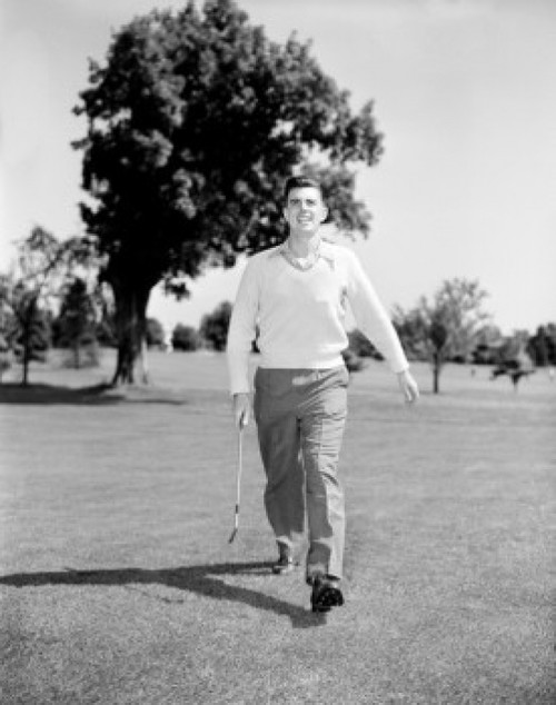 Young man playing golf Poster Print