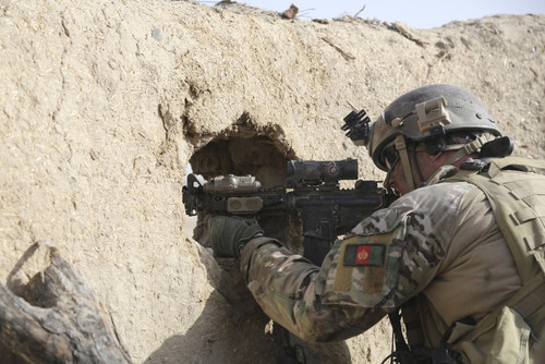 A U.S. Special Forces Soldier returns fire from an outpost in Afghanistan Poster Print
