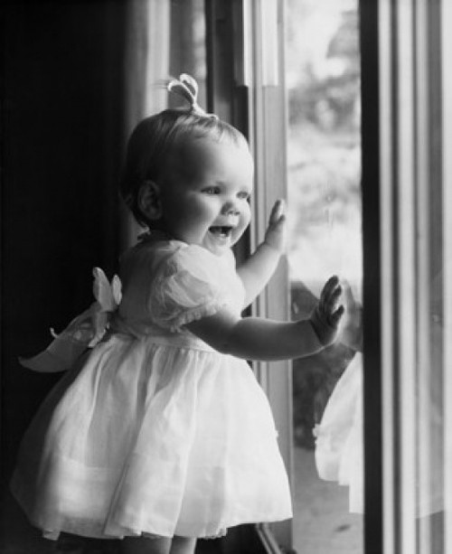 Close-up of a baby girl standing near a window Poster Print - Item # VARSAL2559406
