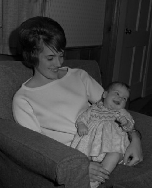Mother sitting in armchair with baby in arms and smiling Poster Print - Item # VARSAL2559854