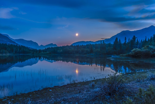 July 2, 2014 - The waxing crescent moon over Middle Lake in Bow Valley Provincial Park, Alberta, Canada, east of Banff and Canmore. Poster Print - Item # VARPSTADY200272S