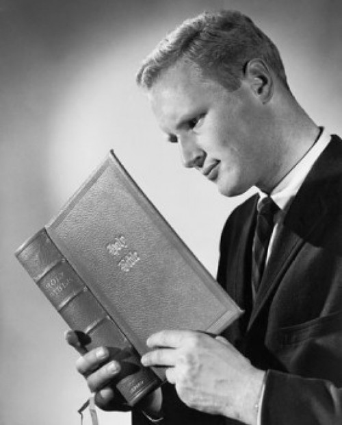 Young man reading the Bible Poster Print - Item # VARSAL25543301