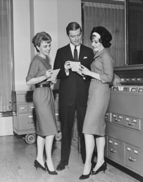 Two businesswomen and a businessman reading documents and smiling Poster Print - Item # VARSAL25543610