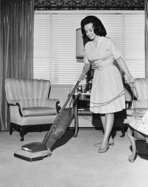 Young woman cleaning carpet with a vacuum cleaner Poster Print - Item # VARSAL25519093