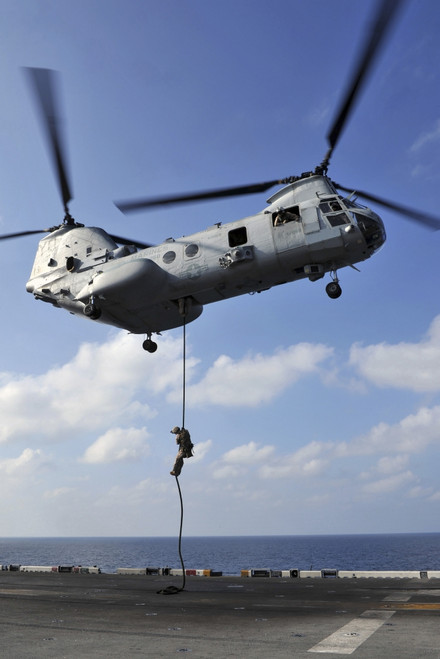 Arabian Sea, January 12, 2012 - A Marine fast ropes from a CH-46E Sea Knight helicopter onto the flight deck of the amphibious assault ship USS Makin Island Poster Print - Item # VARPSTSTK105248M