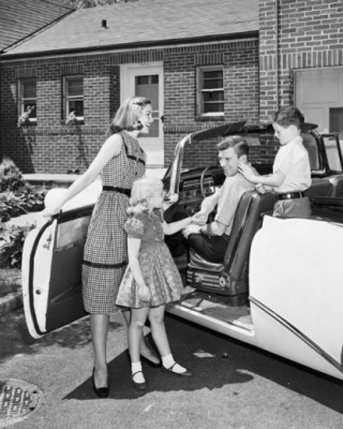 Mid adult woman and her daughter standing beside a car with a mid adult man and his son sitting in a car Poster Print - Item # VARSAL25511950