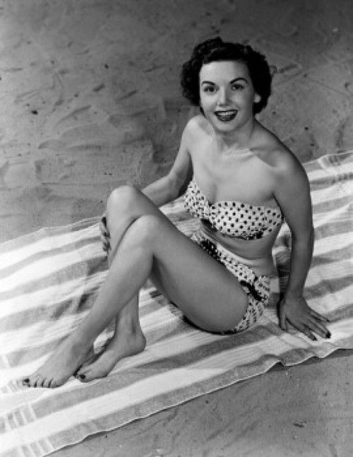 Portrait of young woman sitting on beach Poster Print - Item # VARSAL255417478