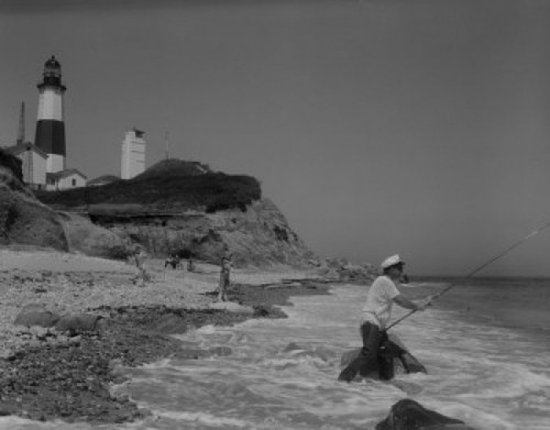 People fishing on seaside  lighthouse in the background Poster Print - Item # VARSAL255421683