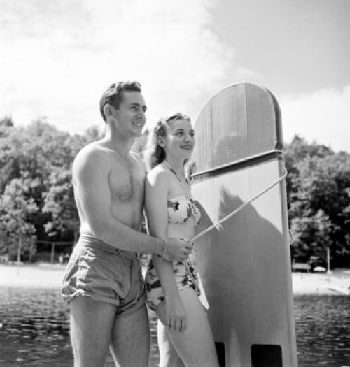 Young couple wearing swimsuits smiling Poster Print - Item # VARSAL255424513
