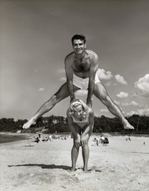 Portrait of a young couple playing leapfrog on the beach Poster Print - Item # VARSAL2556620