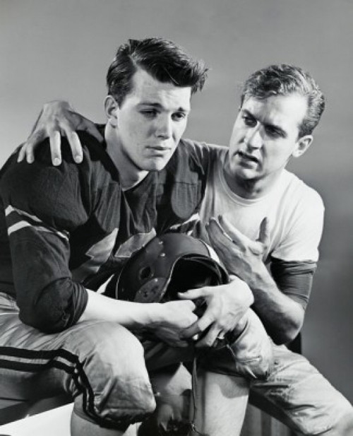 Young man consoling a football player Poster Print - Item # VARSAL25521767