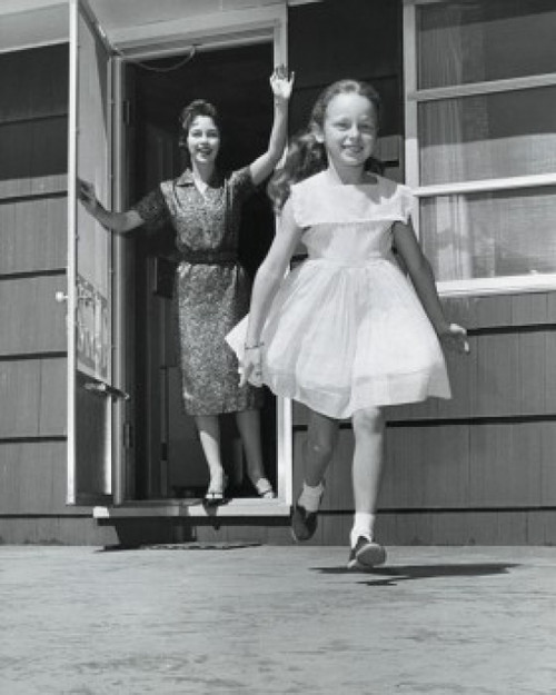 Mid adult woman standing in the doorway and waving to her daughter Poster Print - Item # VARSAL25519856