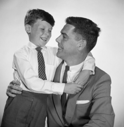 Portrait of father and son embracing Poster Print