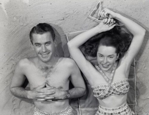 Overhead portrait of young couple relaxing on beach Poster Print
