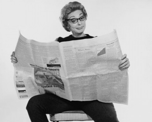Mid adult woman reading a financial newspaper and making a face Poster Print - Item # VARSAL25541825