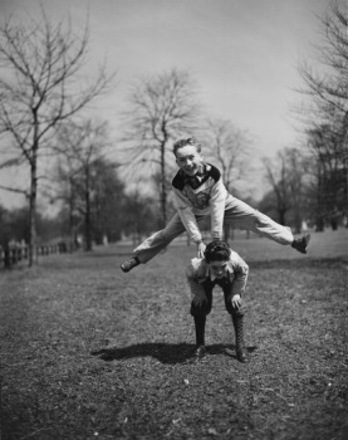 Two boys leapfrogging in park Poster Print - Item # VARSAL255422358