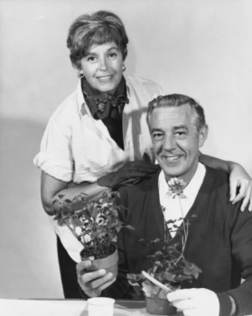 Mature man holding a potted plant with a mature woman standing behind him Poster Print - Item # VARSAL25528218