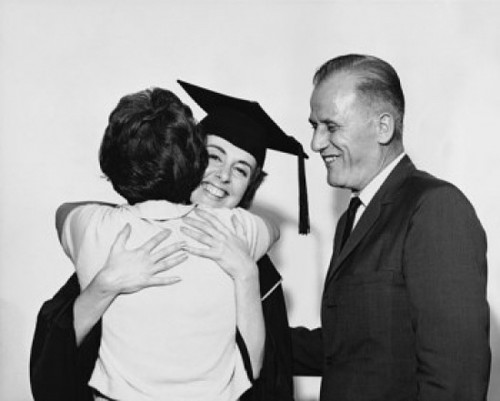 Female graduate hugging a woman with a mature man standing beside her Poster Print - Item # VARSAL25518858