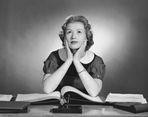 Businesswoman sitting at a desk and thinking in an office Poster Print - Item # VARSAL25528038