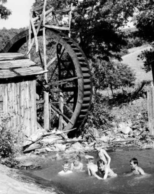 Boys swimming in water in front of watermill Poster Print - Item # VARSAL25516735