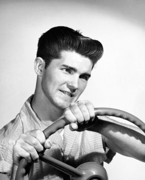Close-up of a young man holding a steering wheel Poster Print - Item # VARSAL2557907