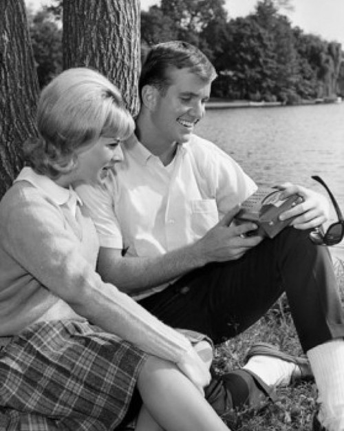 Young couple sitting at side of pond Poster Print - Item # VARSAL25526852