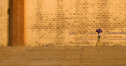 Woman Carrying Bundle On Her Head On The Ghats By The River; The Ganges,Varanasi,India PosterPrint