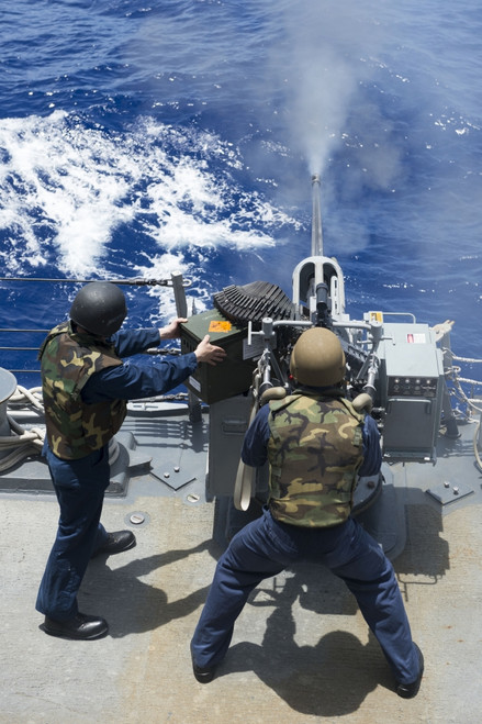 Philippine Sea, August 11, 2013 - Electronics Technician fires a 25mm machine gun aboard the guided-missile destroyer USS Preble during a live-fire weapons shoot. Poster Print - Item # VARPSTSTK107755M