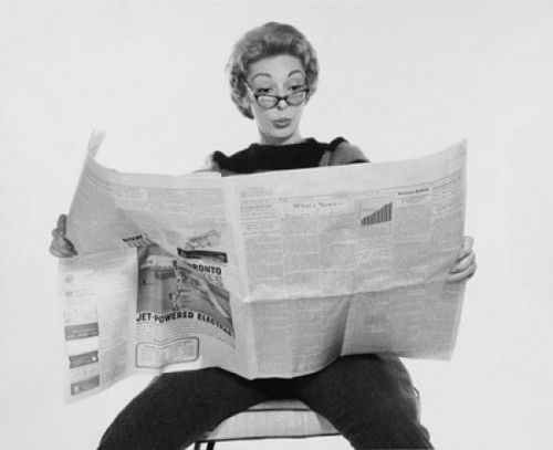 Mid adult woman reading a financial newspaper and making a face Poster Print - Item # VARSAL25541826