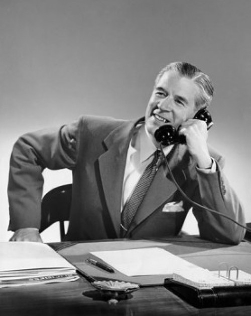 Mature businessman talking on telephone in office Poster Print - Item # VARSAL25548247