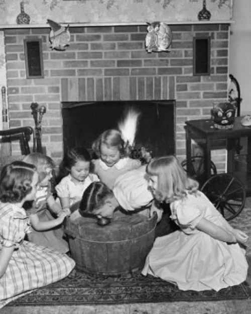 High angle view of a boy bobbing for apples with girls around him Poster Print - Item # VARSAL25518574