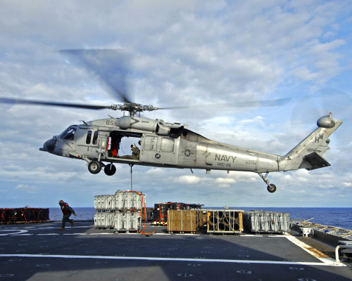 Atlantic Ocean, December 14, 2006 - An MH-60S Seahawk helicopter prepares to deliver ammunition to flight deck of USS Theodore Roosevelt Poster Print - Item # VARPSTSTK101945M
