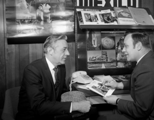 Two men talking in travel agency Poster Print - Item # VARSAL255416287