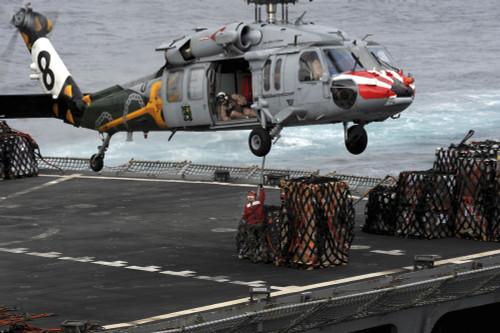 A Sailor hooks cargo to an MH-60S Sea Hawk helicopter Poster Print - Item # VARPSTSTK104973M