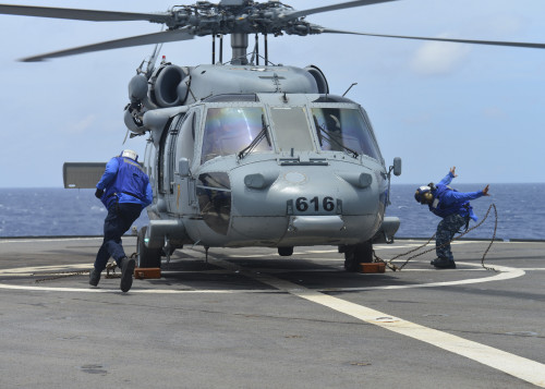 South China Sea, June 3, 2014 - Boatswain's Mates remove the chocks and chains from an MH-60S Sea Hawk helicopter before takeoff aboard the U.S. 7th Fleet flagship USS Blue Ridge. Poster Print - Item # VARPSTSTK108321M