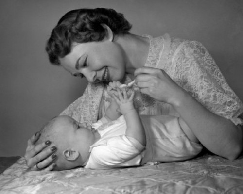 Young woman playing with baby on bed Poster Print - Item # VARSAL2559867