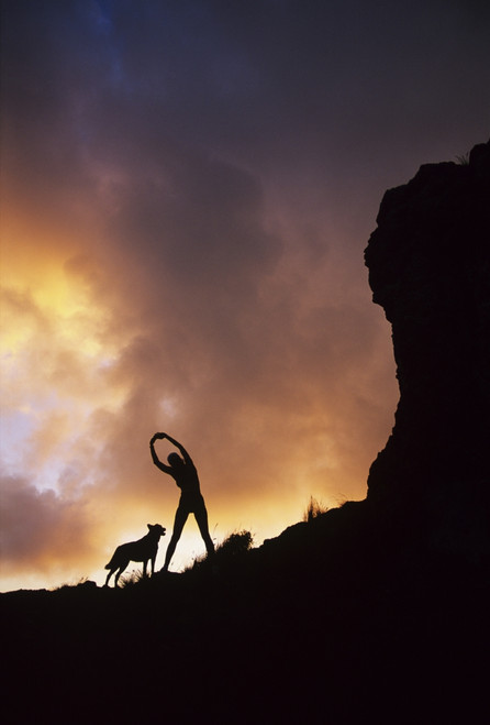 Hawaii, Silhouette Of A Woman Stretching On A Mountain Top At Sunset. PosterPrint - Item # VARDPI1974344