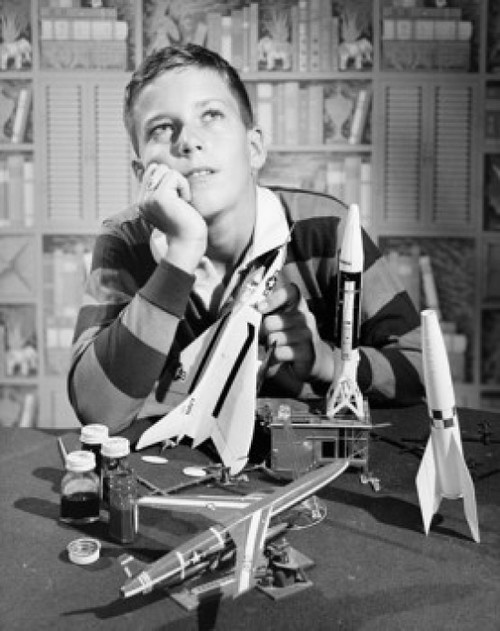 Boy holding model airplane and looking up Poster Print - Item # VARSAL25550151