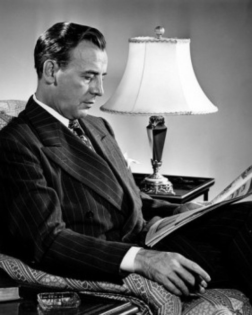 Man sitting in armchair reading newspaper Poster Print - Item # VARSAL25549365