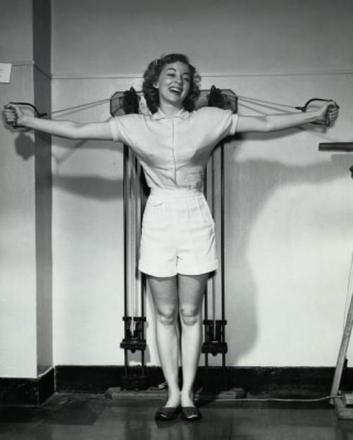 Young woman exercising in a gym and smiling Poster Print - Item # VARSAL25540092 Young woman exercising in a gym and smiling Poster Print - Item # VARSAL25540092