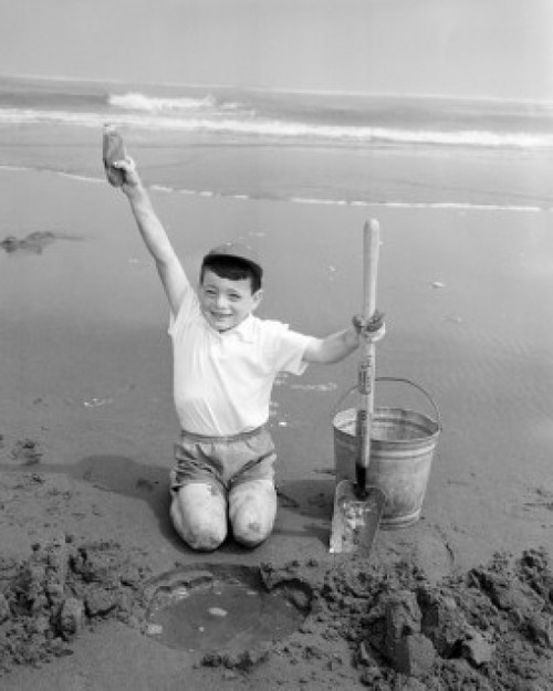 USA  Oregon  boy digging in sand on beach Poster Print - Item # VARSAL255424478