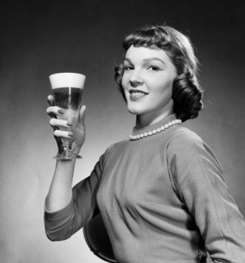 Portrait of young woman holding glass of beer Poster Print - Item # VARSAL2554235