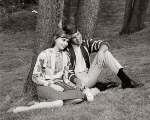 Teenage couple sitting in park listening to radio Poster Print - Item # VARSAL2557550