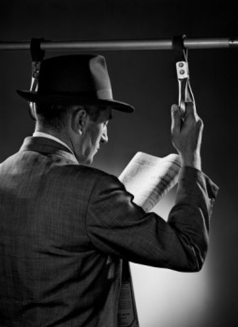 Man standing and reading newspaper  studio shot Poster Print - Item # VARSAL255416537