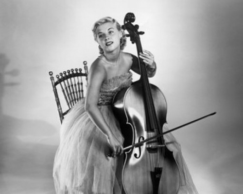 Young woman sitting on a chair and playing a cello Poster Print - Item # VARSAL2553372B